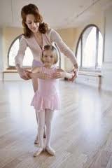 Ballet Teacher Helping a Young Ballet Student